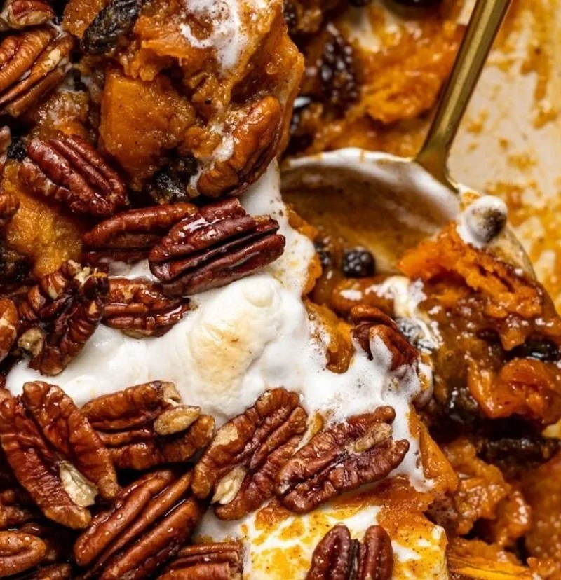 Southern Maple Sweet Potato Casserole topped with pecans and maple syrup.