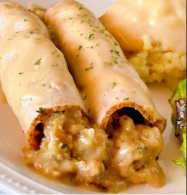 Turkey Roll Ups with Stuffing and Creamy Gravy served on a plate