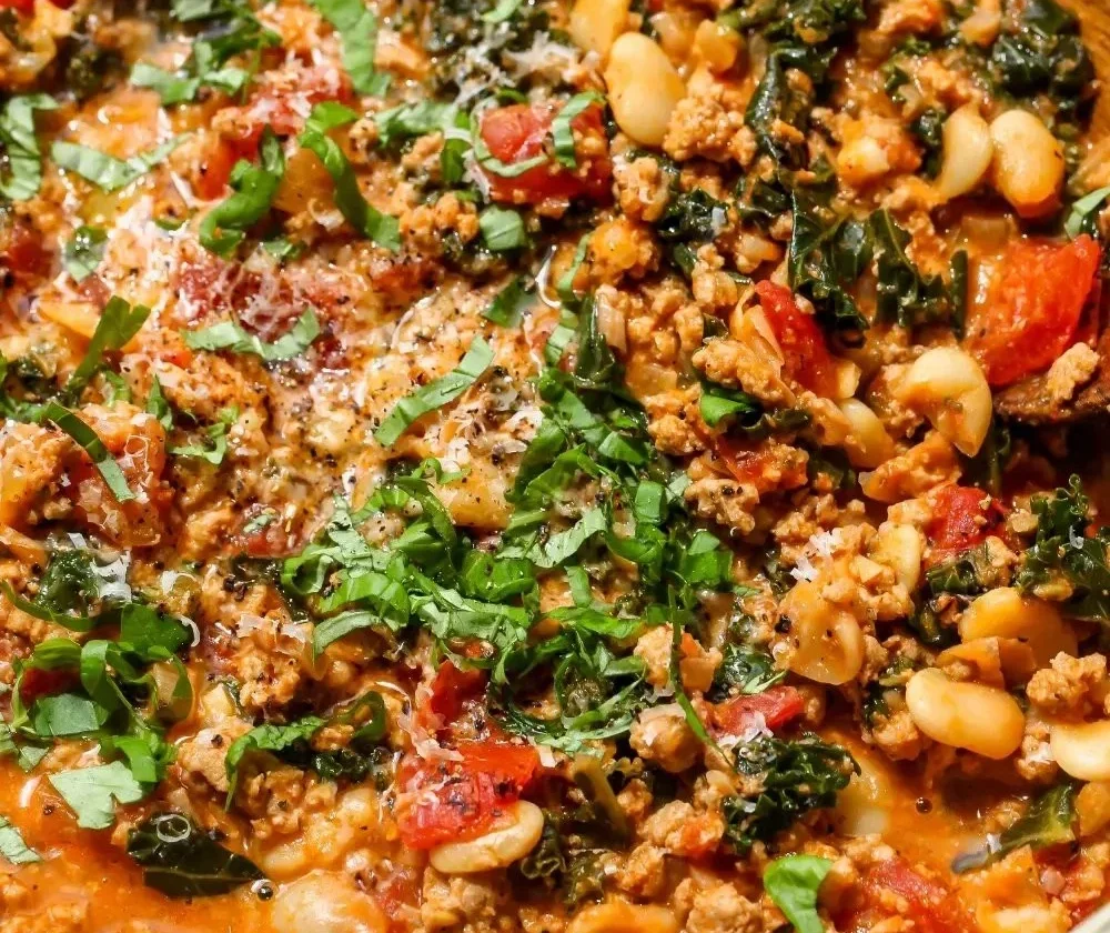 Delicious Tuscan Turkey with White Beans Skillet served in a cast iron pan.