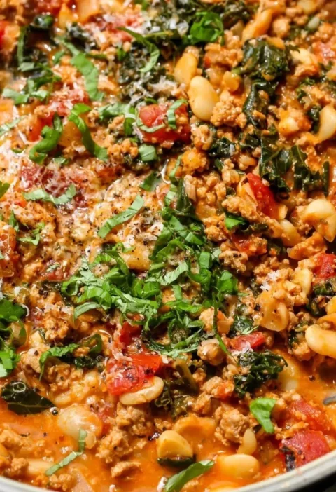 Delicious Tuscan Turkey with White Beans Skillet served in a cast iron pan.