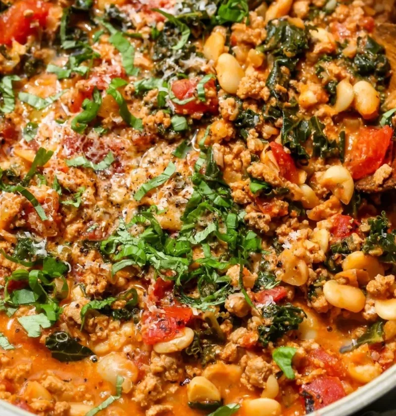 Delicious Tuscan Turkey with White Beans Skillet served in a cast iron pan.